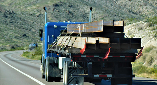 Steel Freight Shipping by Flatbed Truck on Highway